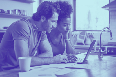 Two people looking at a computer